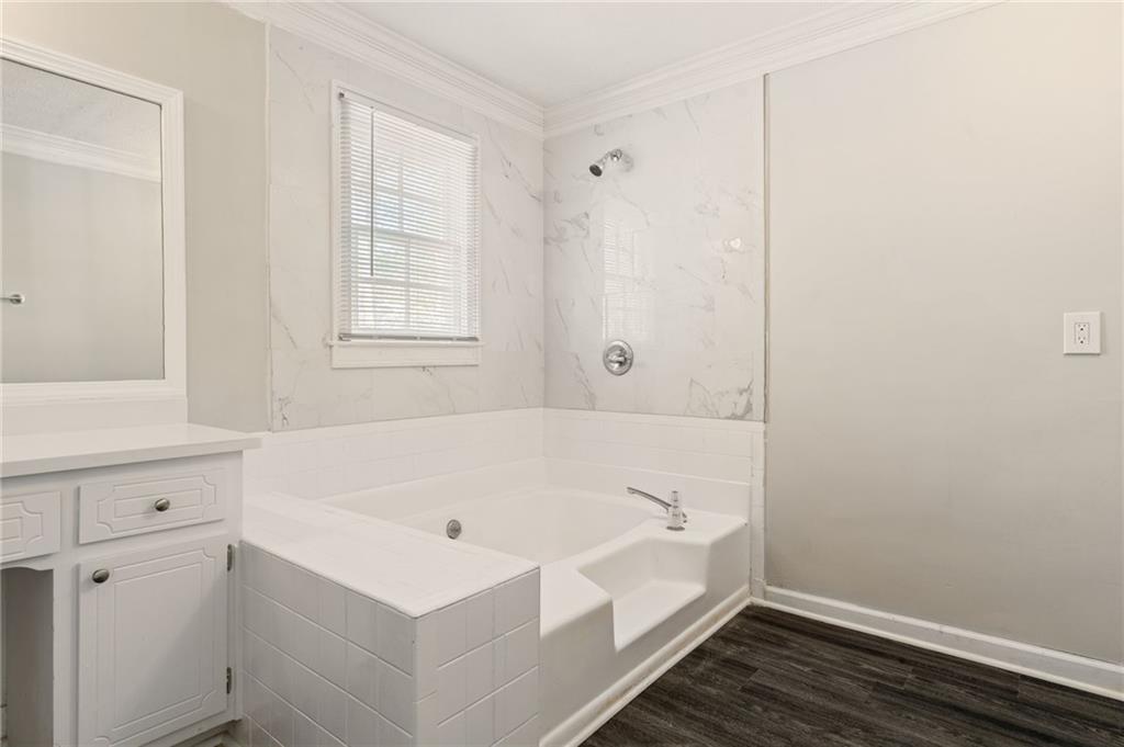 835 Lockriver Way Lawrenceville, GA 30044 - Photo 23 of 68 a bathroom with a bathtub and a window