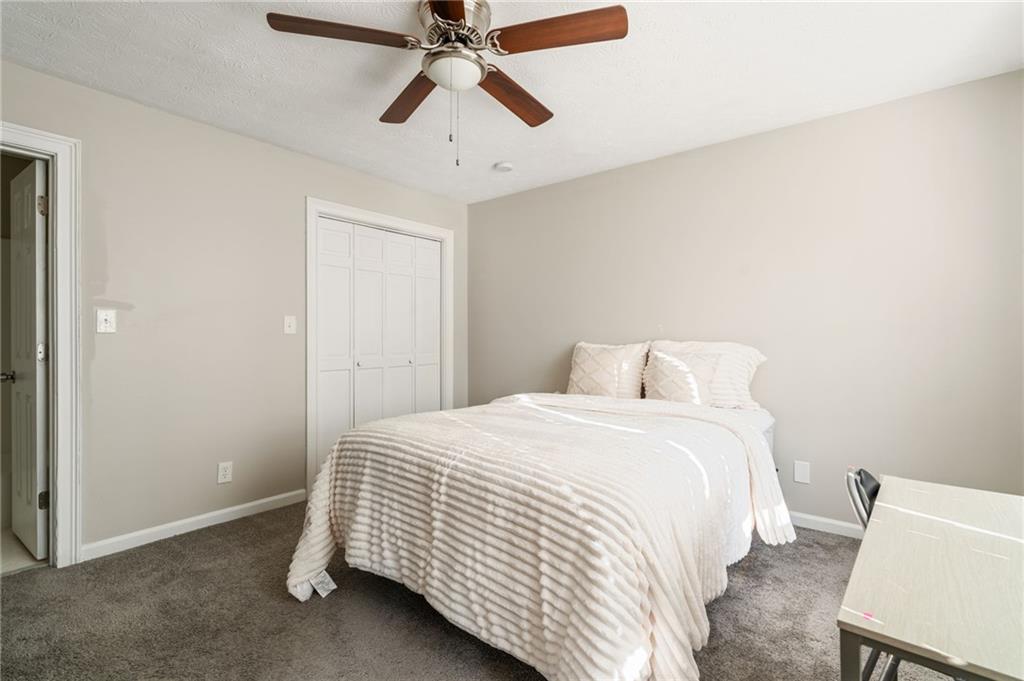 835 Lockriver Way Lawrenceville, GA 30044 - Photo 25 of 68 a bedroom with a bed and a chandelier