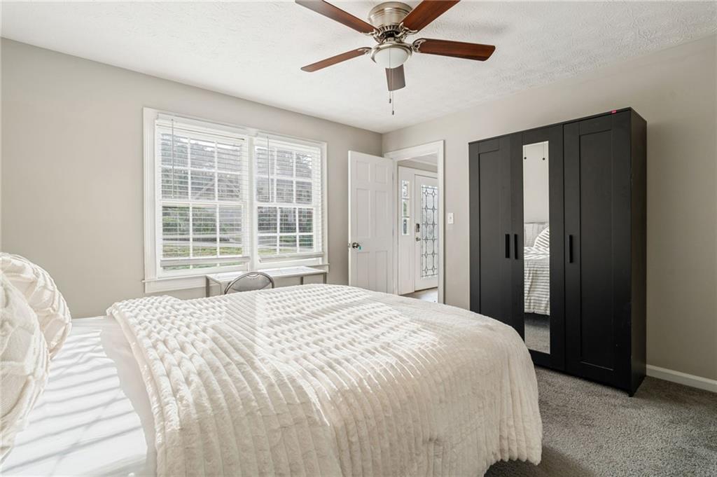 835 Lockriver Way Lawrenceville, GA 30044 - Photo 26 of 68 a bedroom with a large bed and ceiling fan