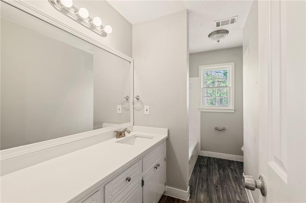 835 Lockriver Way Lawrenceville, GA 30044 - Photo 27 of 68 a bathroom with a sink a mirror and a toilet