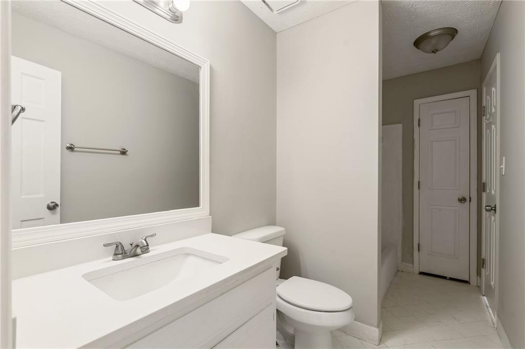 835 Lockriver Way Lawrenceville, GA 30044 - Photo 29 of 68 a bathroom with a sink a toilet and a mirror
