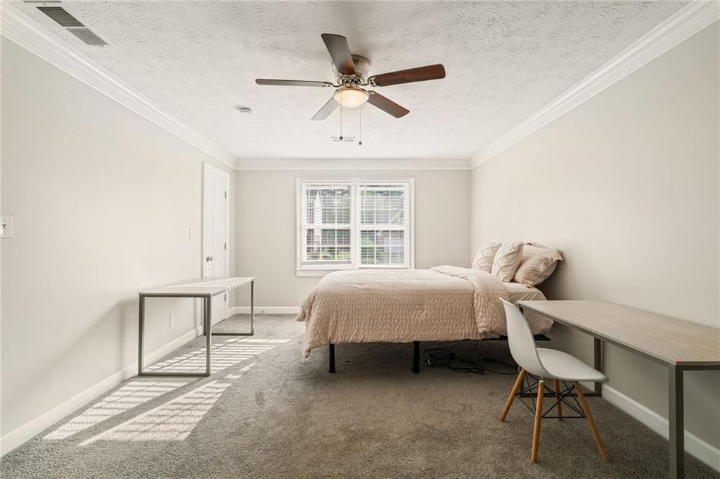 835 Lockriver Way Lawrenceville, GA 30044 - Photo 32 of 68 a bed room with a bed and a chair