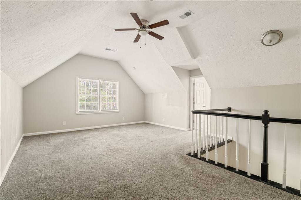 835 Lockriver Way Lawrenceville, GA 30044 - Photo 33 of 68 an empty room with ceiling fan and windows