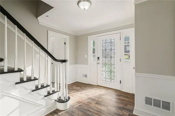 a view of entryway and hall with wooden floor