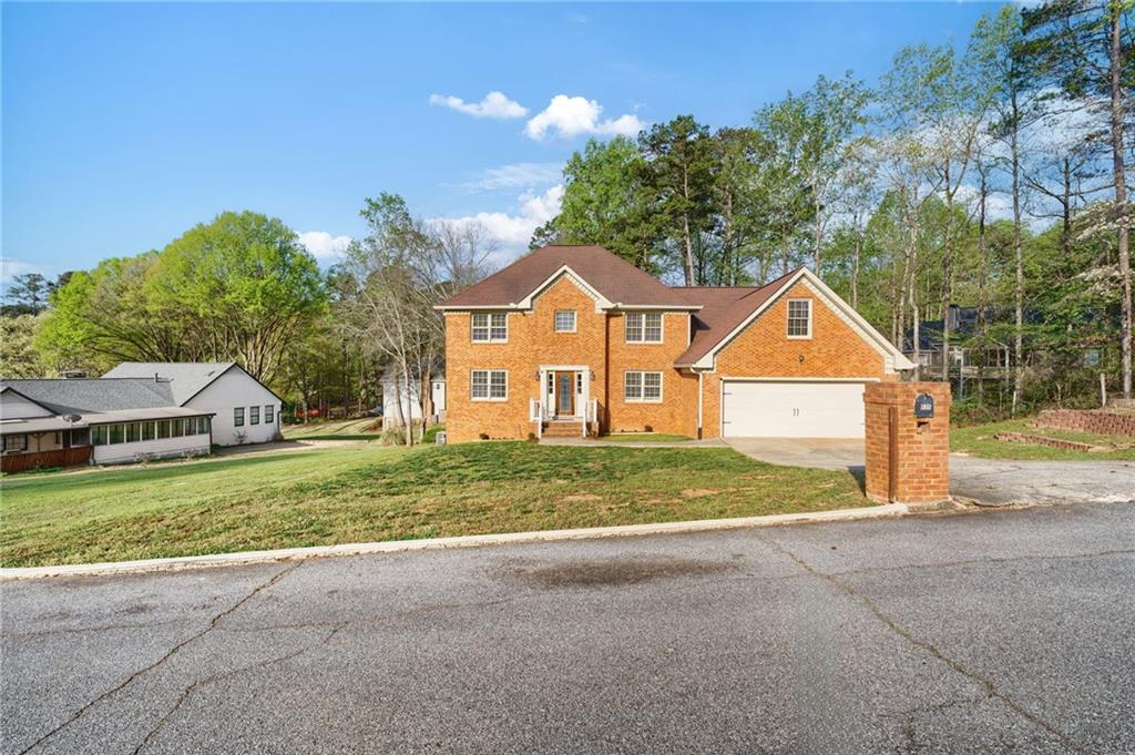 835 Lockriver Way Lawrenceville, GA 30044 - Photo 52 of 68 a front view of a house with a yard and garage