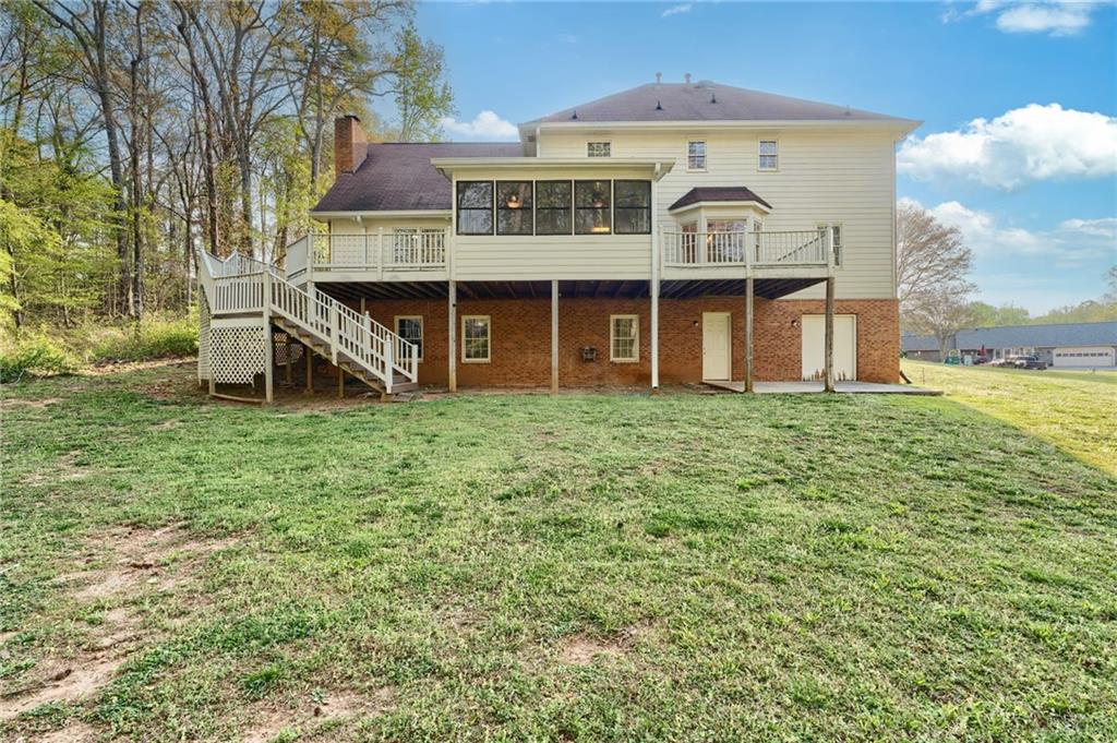 835 Lockriver Way Lawrenceville, GA 30044 - Photo 54 of 68 a view of a big house with a big yard and large trees