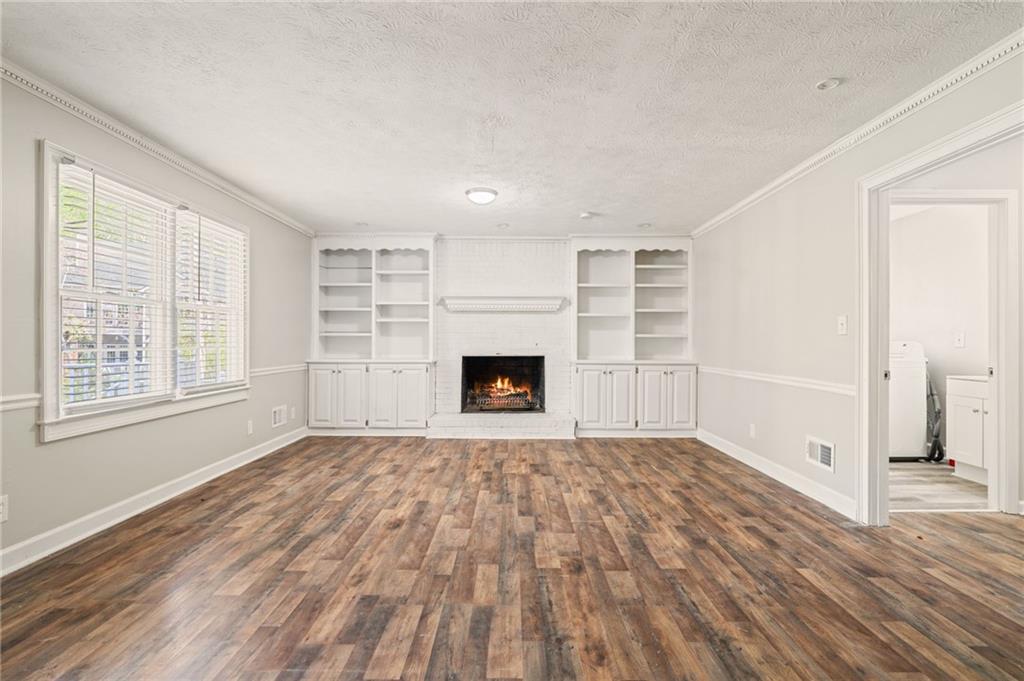 835 Lockriver Way Lawrenceville, GA 30044 - Photo 58 of 68 a view of empty room with wooden floor and fireplace