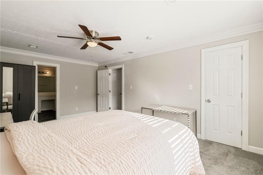 835 Lockriver Way Lawrenceville, GA 30044 - Photo 59 of 68 a bedroom with a bed and a closet