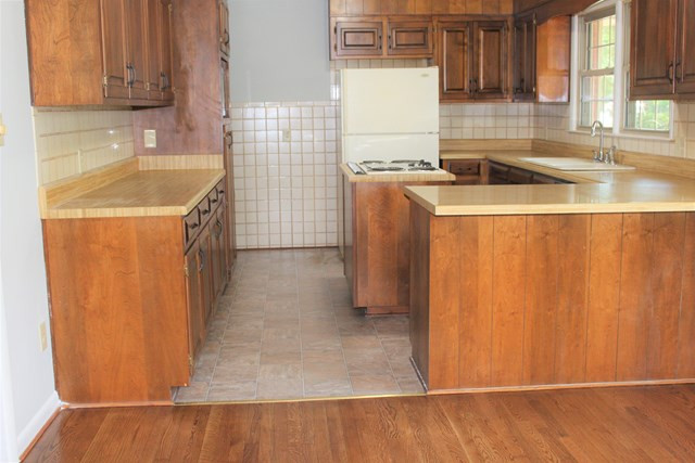 1148 Whiskey Road Aiken, SC 29801 - Photo 4 of 20 a kitchen with a sink a stove and cabinets