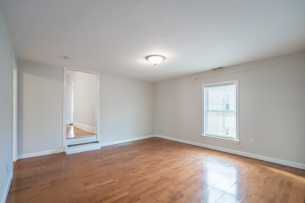 131 Summer Street, Unit 2 Somerville, MA 02143 - Photo 11 of 15 an empty room with a window