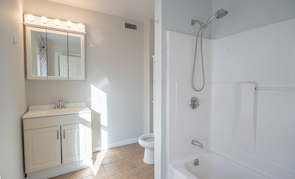 131 Summer Street, Unit 2 Somerville, MA 02143 - Photo 2 of 15 a bathroom with a sink a toilet and shower