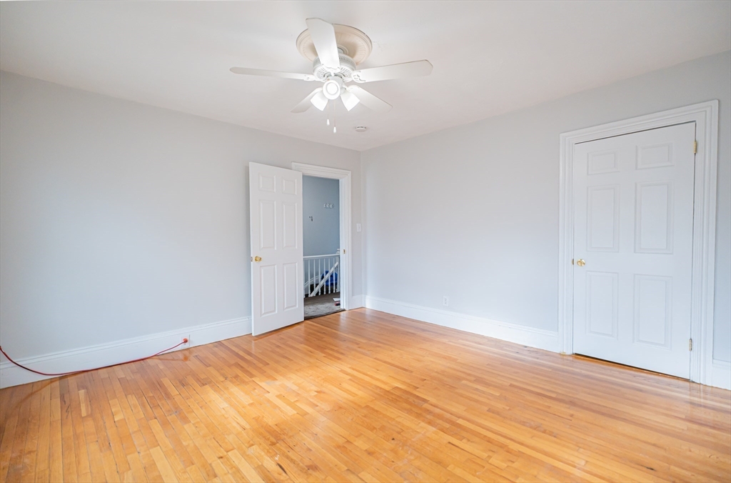 131 Summer Street, Unit 2 Somerville, MA 02143 - Photo 5 of 15 a view of empty room with wooden floor