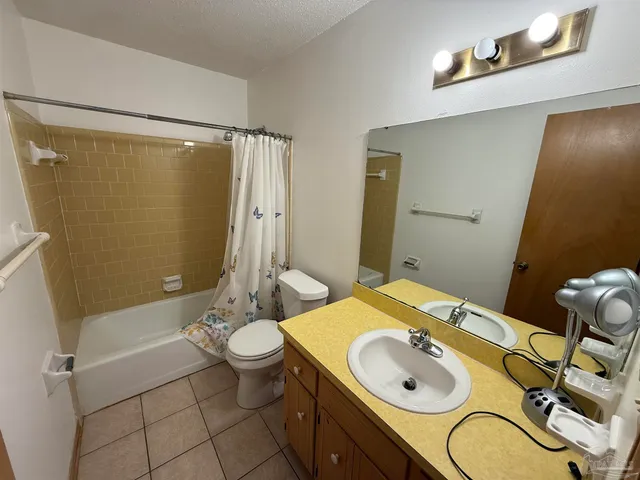 a view of a cabinet and a chandelier fan in a room