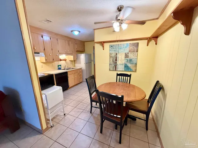 a view of a dining room with furniture and a chandelier