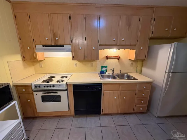 a kitchen with stainless steel appliances granite countertop a stove a refrigerator and a cabinets