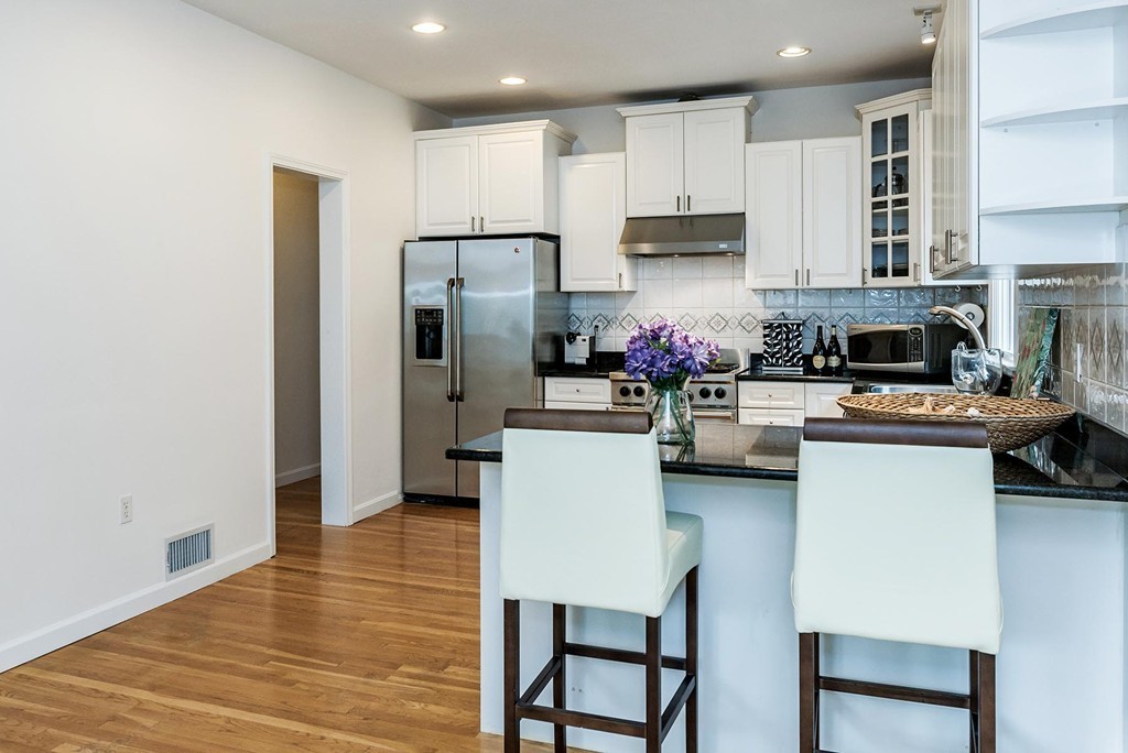 200 Country Club Road Newton, MA 02459 - Photo 5 of 12 a kitchen with refrigerator a stove and cabinets