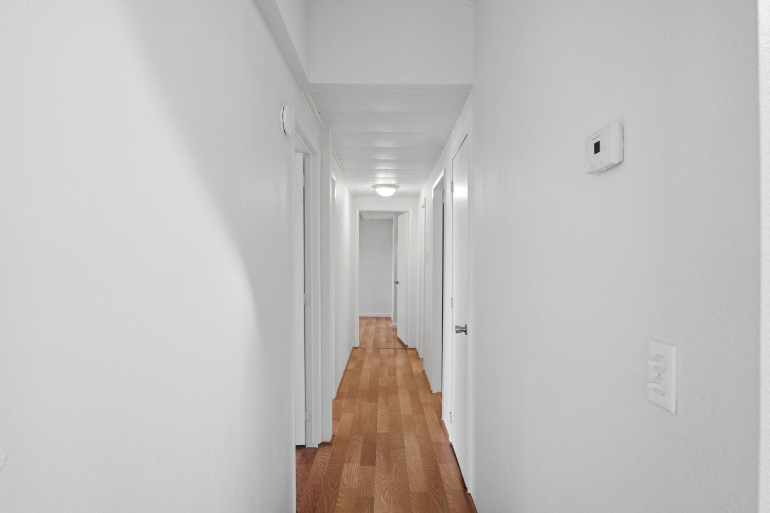 1428 Playground Way Modesto, CA 95355 - Photo 15 of 29 a view of a hallway with wooden floor
