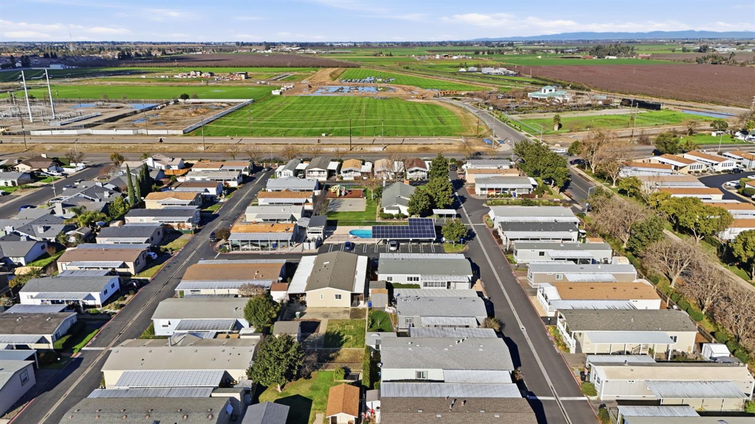1428 Playground Way Modesto, CA 95355 - Photo 25 of 29 an aerial view of a city with lots of residential buildings and ocean view in back