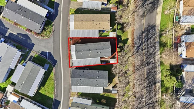 an aerial view of a house with a yard