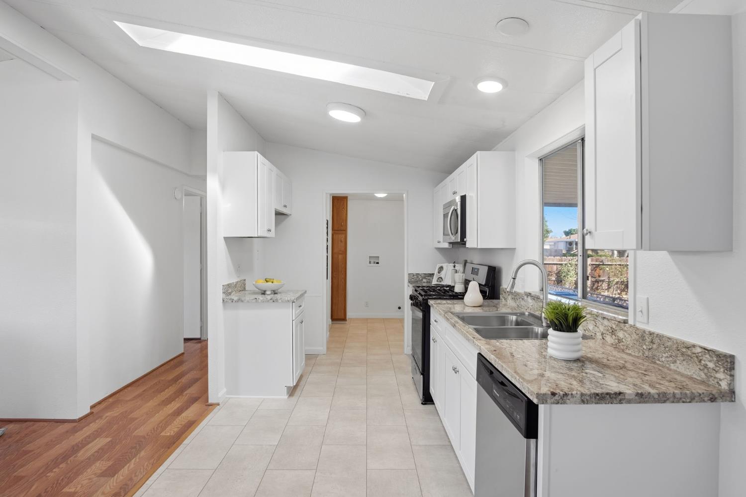 1428 Playground Way Modesto, CA 95355 - Photo 4 of 29 a kitchen with a sink stove and refrigerator