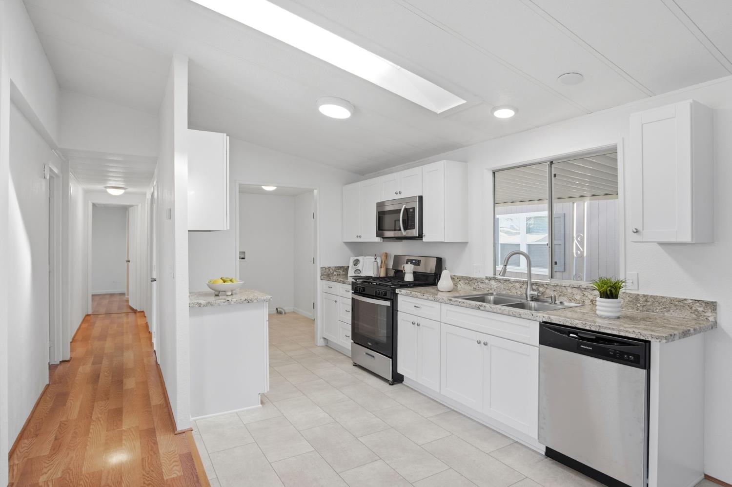 1428 Playground Way Modesto, CA 95355 - Photo 5 of 29 a kitchen with a sink stove and cabinets