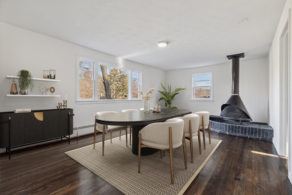 62 Cedar Hill Road Ashland, MA 01721 - Photo 4 of 11 a living room with furniture a dining table and paintings on the wall
