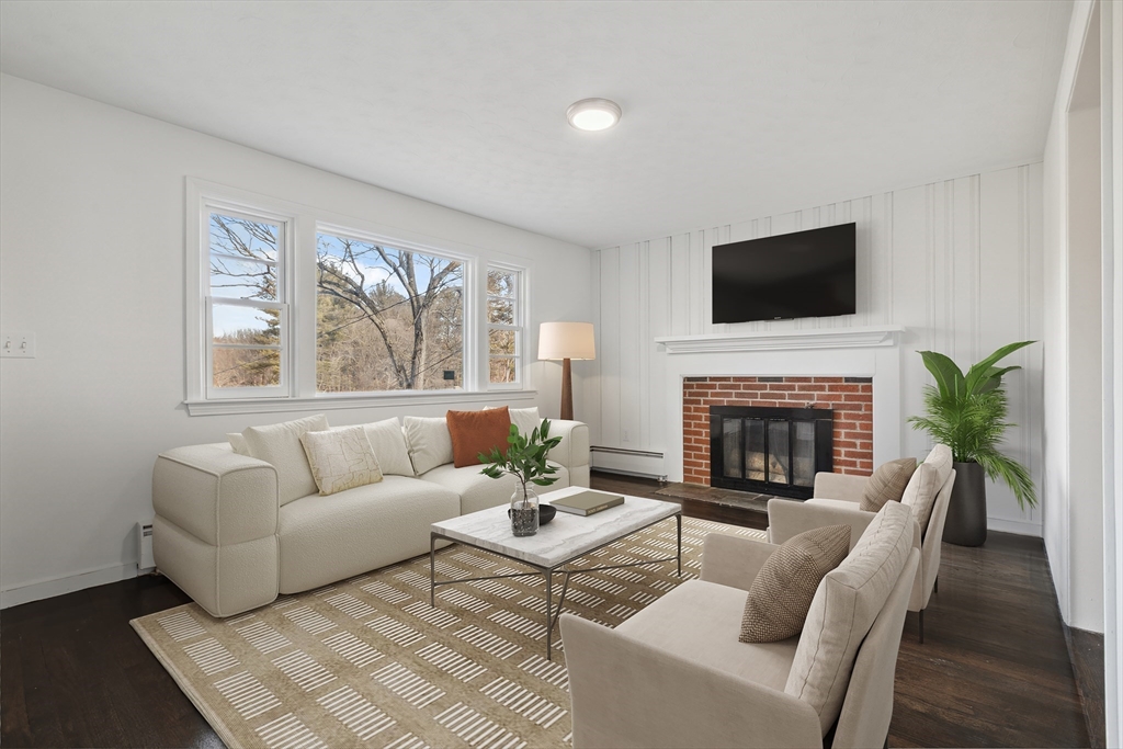 62 Cedar Hill Road Ashland, MA 01721 - Photo 5 of 11 a living room with furniture a flat screen tv and a fireplace