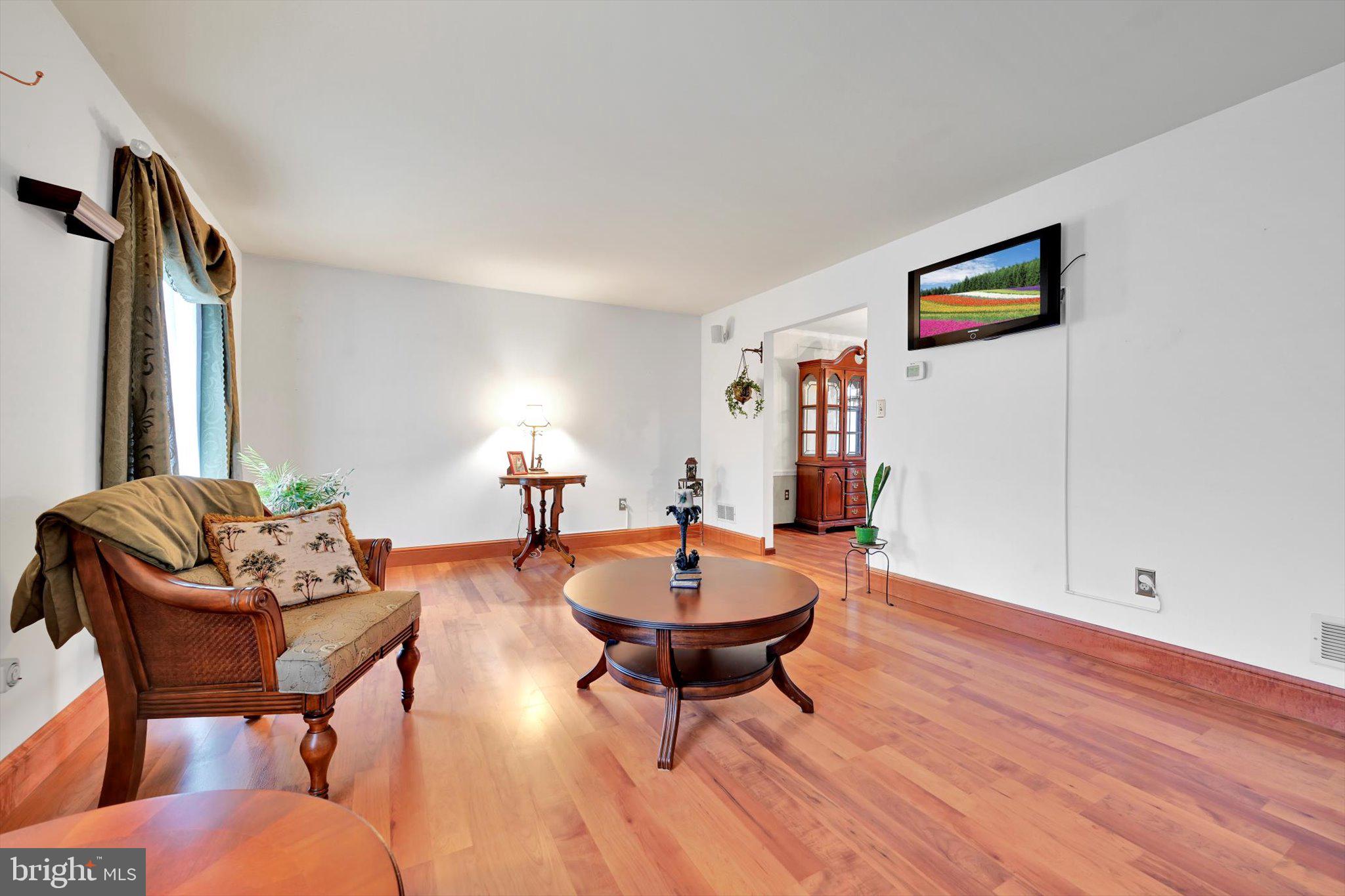 1546 Singer Road Wyomissing, PA 19610 - Photo 13 of 40 a living room with furniture a window and a lamp