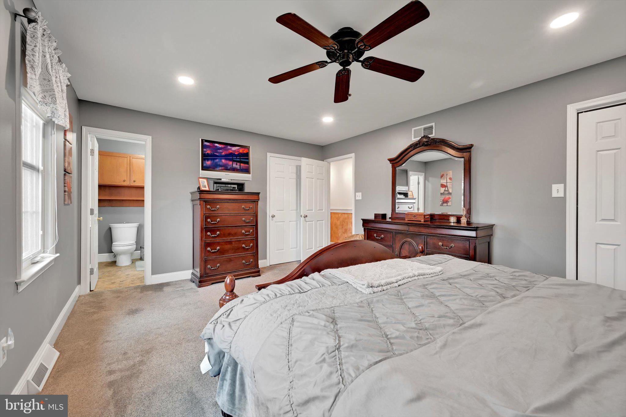 1546 Singer Road Wyomissing, PA 19610 - Photo 18 of 40 a bedroom with a large bed and a flat screen tv