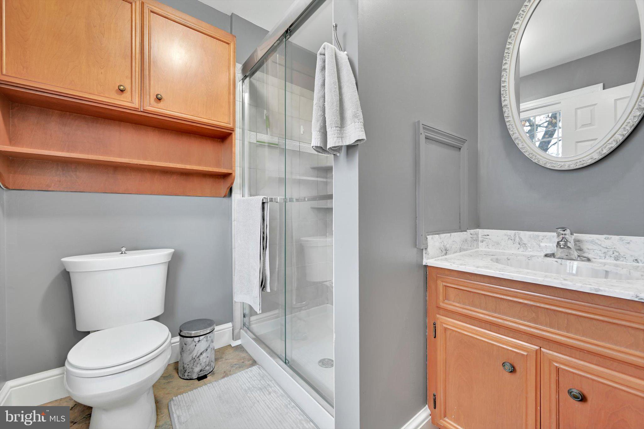 1546 Singer Road Wyomissing, PA 19610 - Photo 19 of 40 a bathroom with a granite countertop toilet sink and mirror