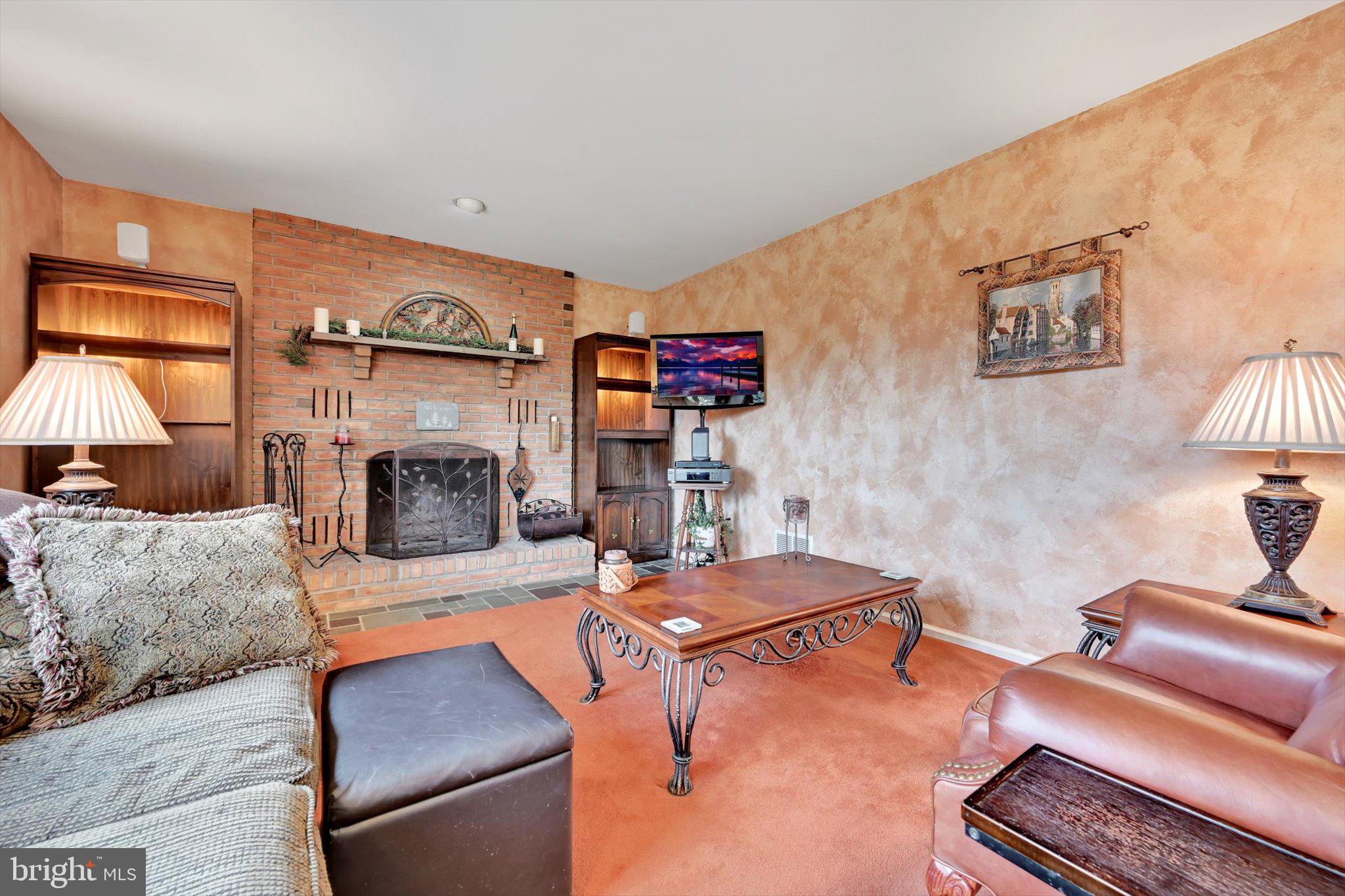 1546 Singer Road Wyomissing, PA 19610 - Photo 2 of 40 a living room with furniture and a fireplace