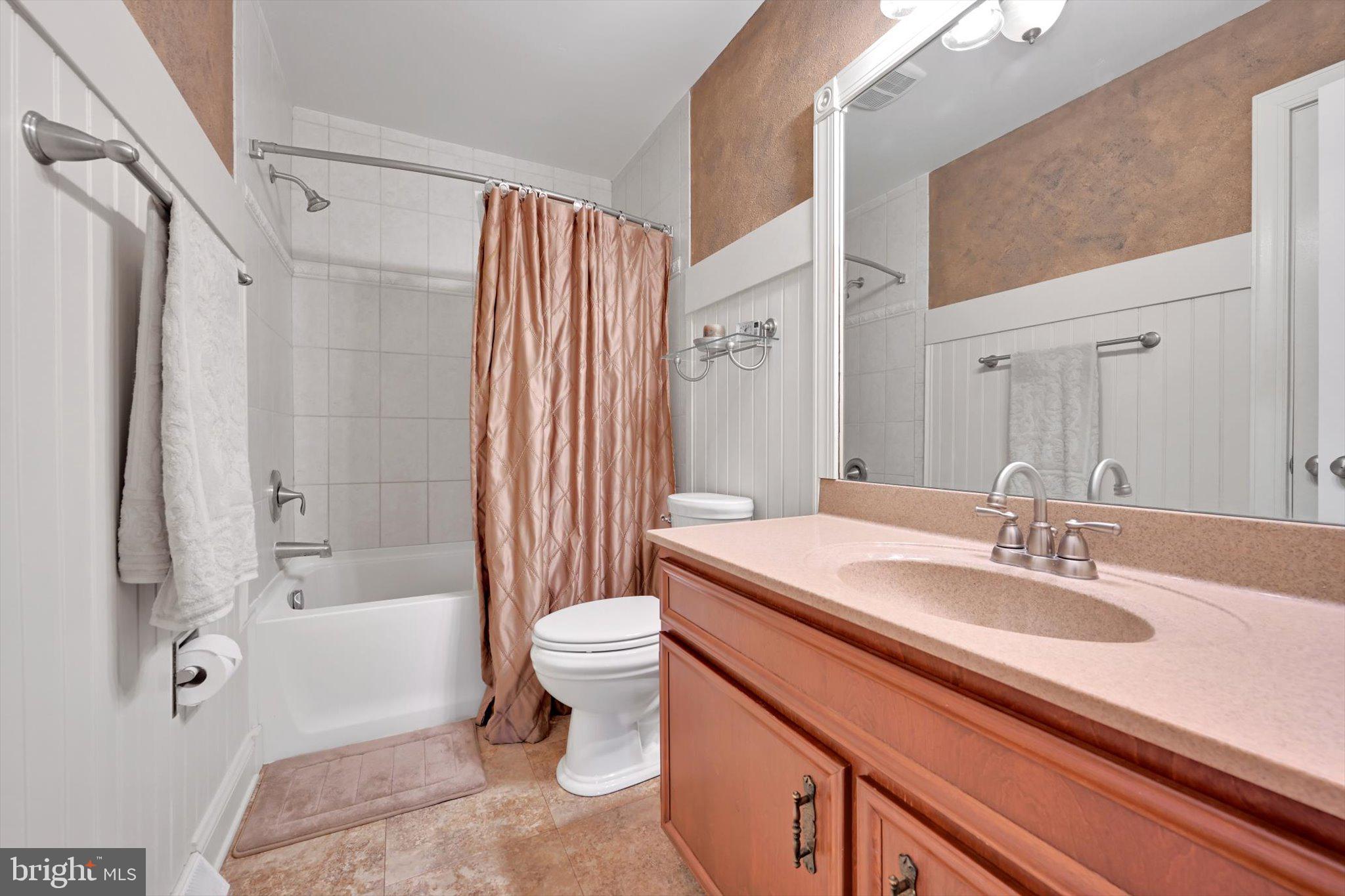 1546 Singer Road Wyomissing, PA 19610 - Photo 24 of 40 a spacious bathroom with a sink a toilet a mirror and a bathtub