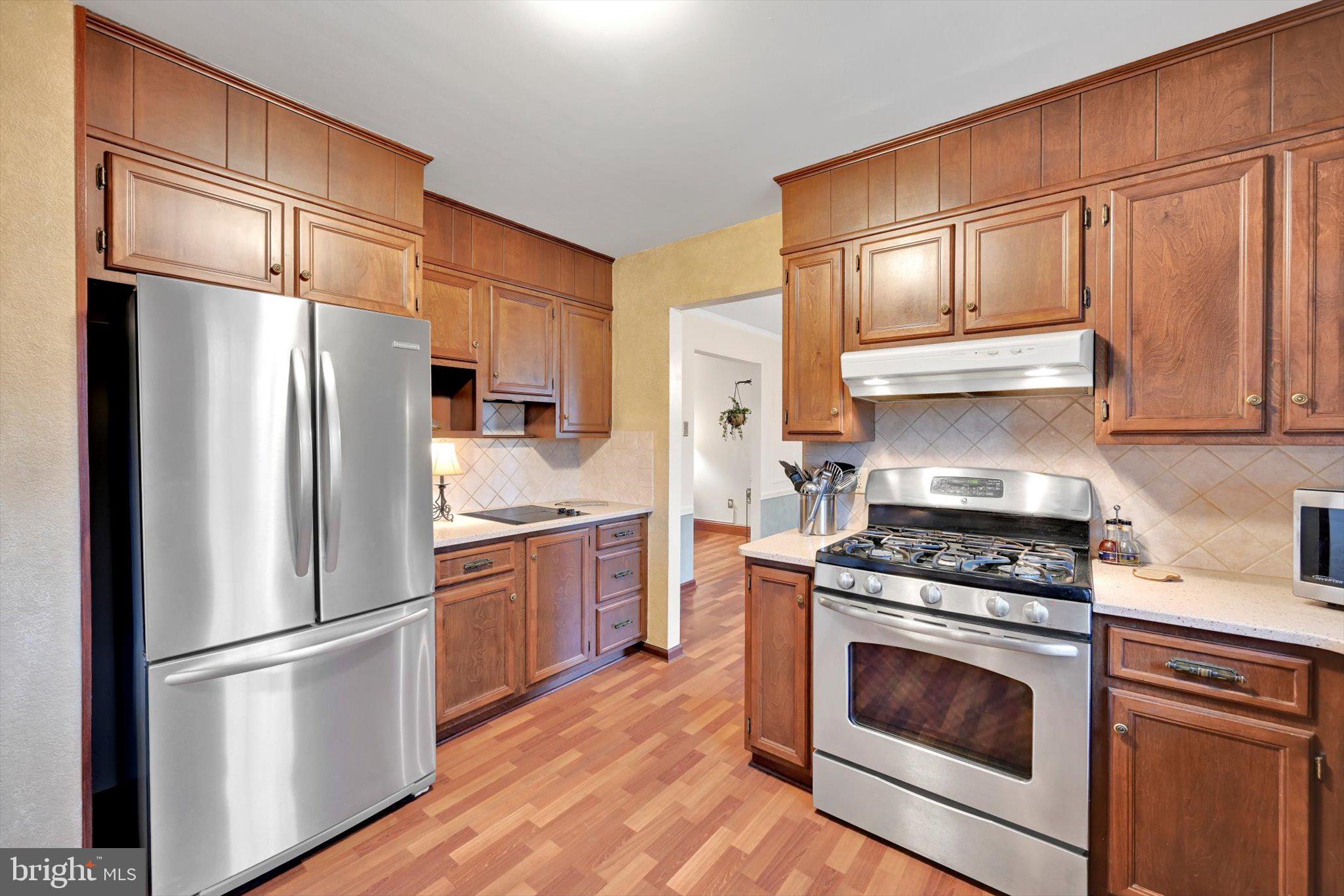1546 Singer Road Wyomissing, PA 19610 - Photo 7 of 40 a kitchen with stainless steel appliances granite countertop a refrigerator stove and sink