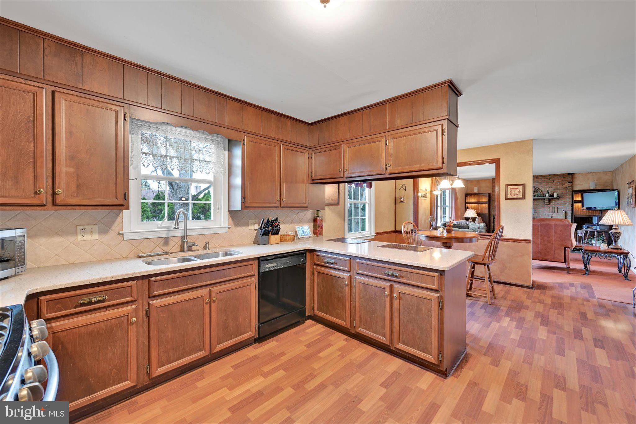 1546 Singer Road Wyomissing, PA 19610 - Photo 8 of 40 a kitchen with stainless steel appliances granite countertop wooden cabinets a sink and dishwasher a oven with wooden floors