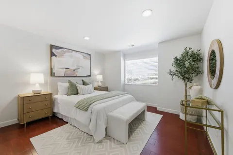 a bedroom with a bed and a potted plant