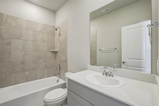 a bathroom with a sink a toilet and a bathtub