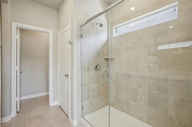 a bathroom with a glass shower door