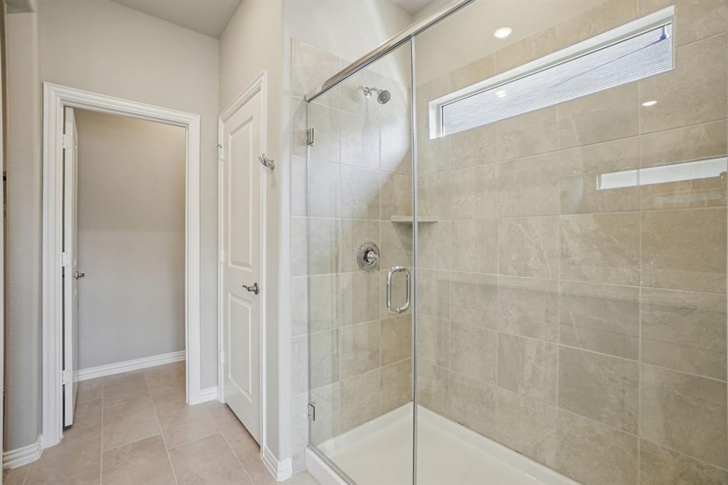 822 Sunflower Road Lavon, TX 75166 - Photo 27 of 38 a bathroom with a glass shower door