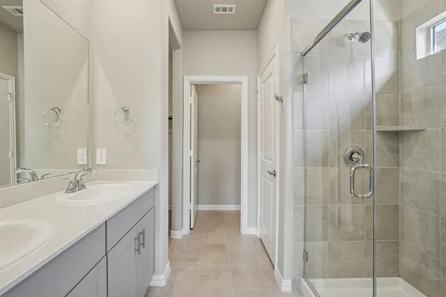 a bathroom with a shower sink and mirror