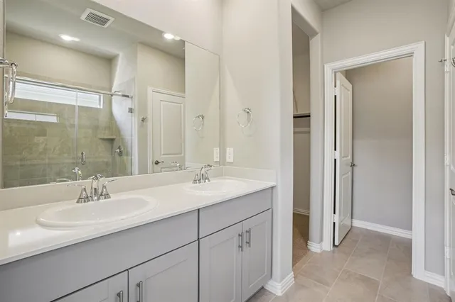 a bathroom with a sink double vanity and a mirror