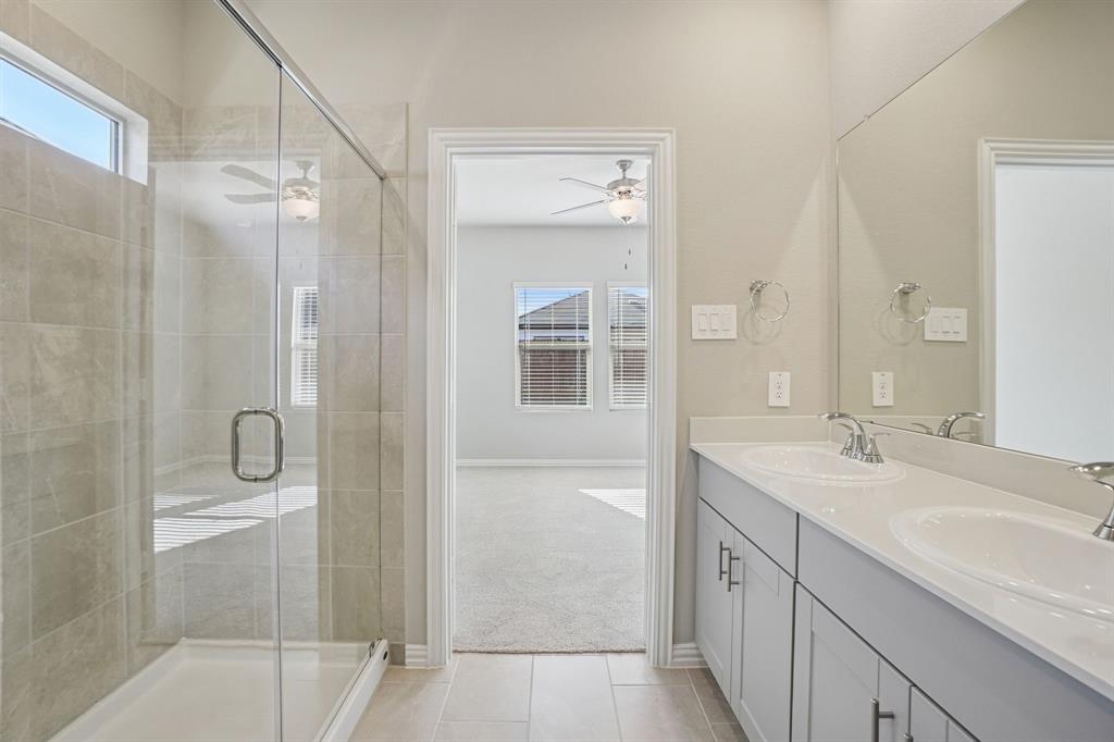 822 Sunflower Road Lavon, TX 75166 - Photo 31 of 38 a bathroom with a shower sink and mirror