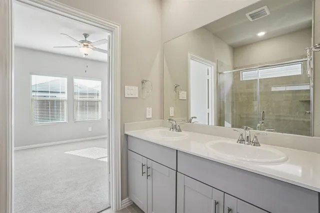 a bathroom with a sink double vanity and shower
