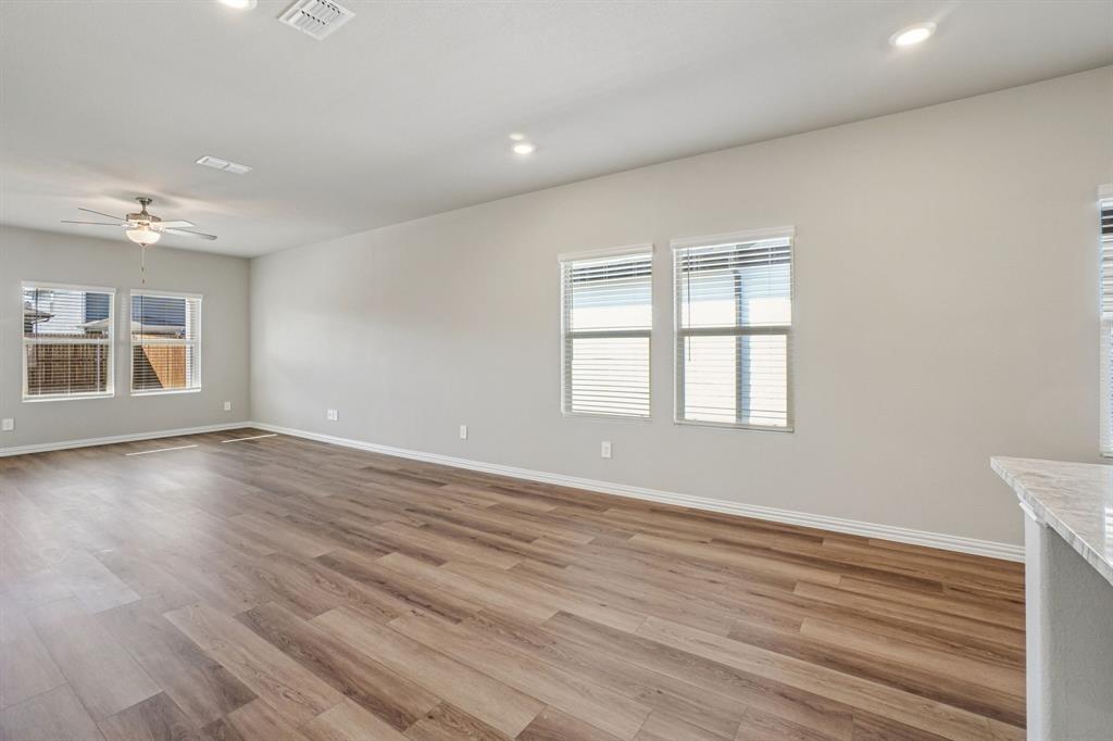 822 Sunflower Road Lavon, TX 75166 - Photo 5 of 38 an empty room with wooden floor and windows