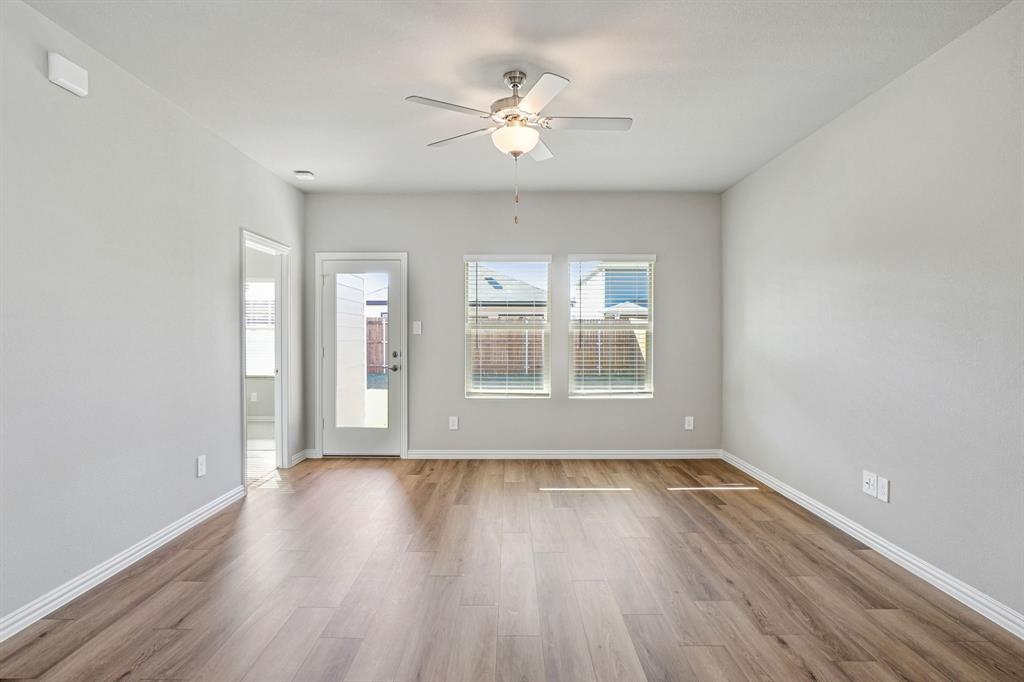 822 Sunflower Road Lavon, TX 75166 - Photo 9 of 38 an empty room with wooden floor and windows