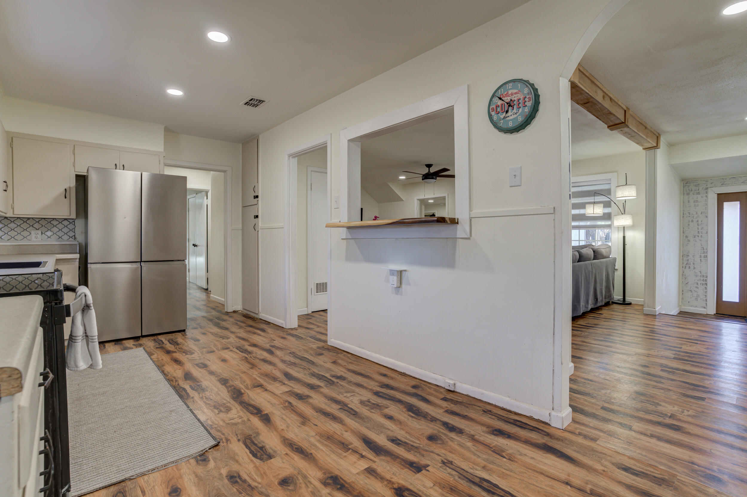 4609 Elgin Avenue Lubbock, TX 79413 - Photo 12 of 46 a view of a refrigerator in kitchen and wooden floor