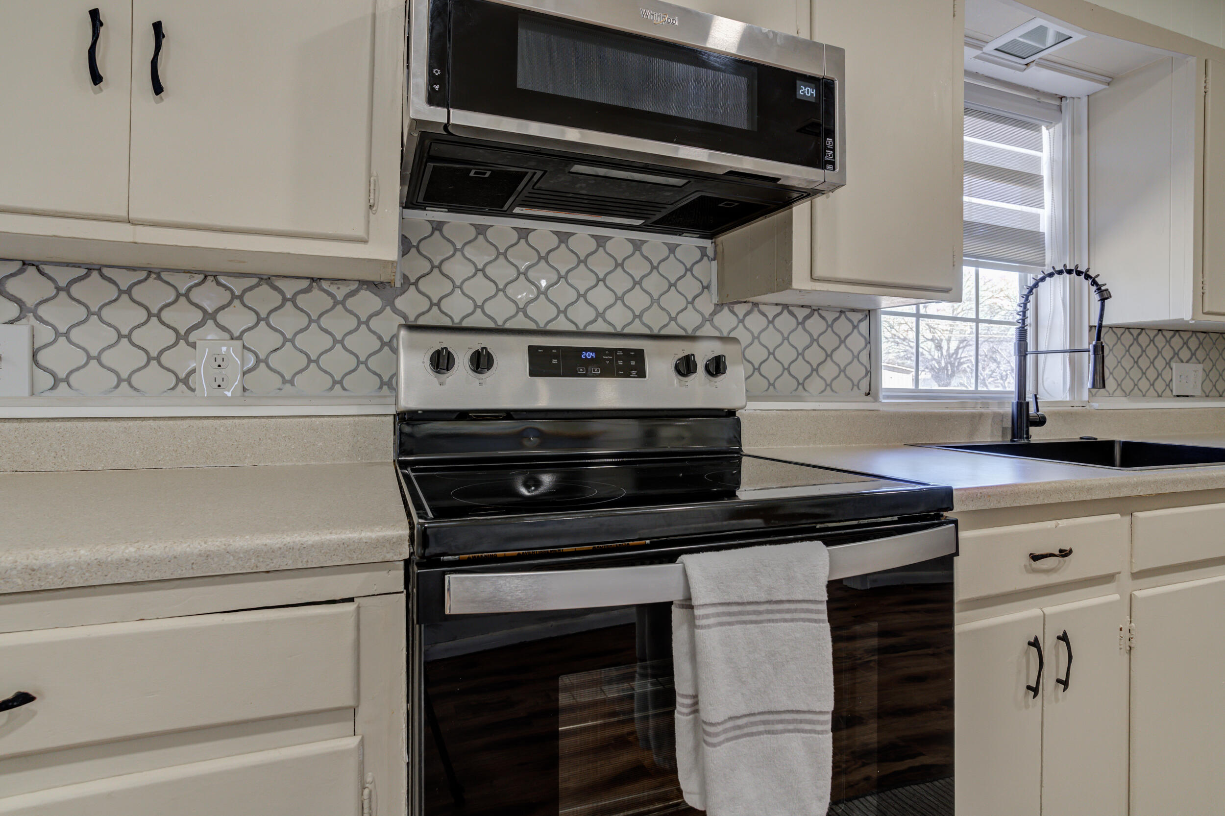 4609 Elgin Avenue Lubbock, TX 79413 - Photo 13 of 46 a kitchen with cabinets and appliances