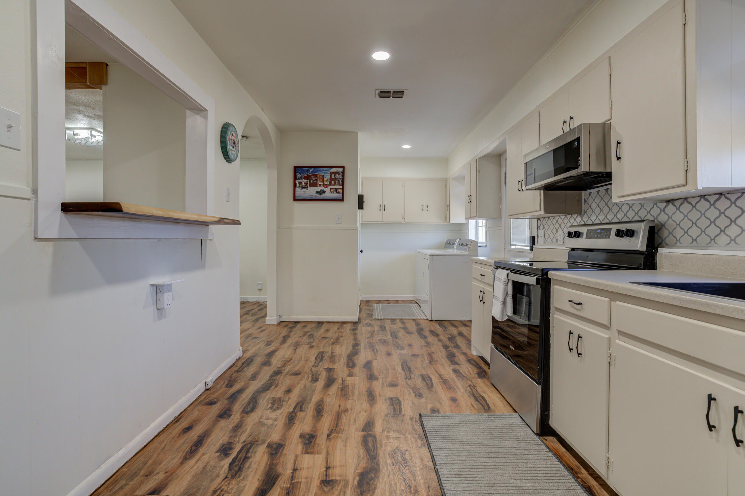 4609 Elgin Avenue Lubbock, TX 79413 - Photo 16 of 46 a kitchen with stainless steel appliances granite countertop a refrigerator and a stove top oven