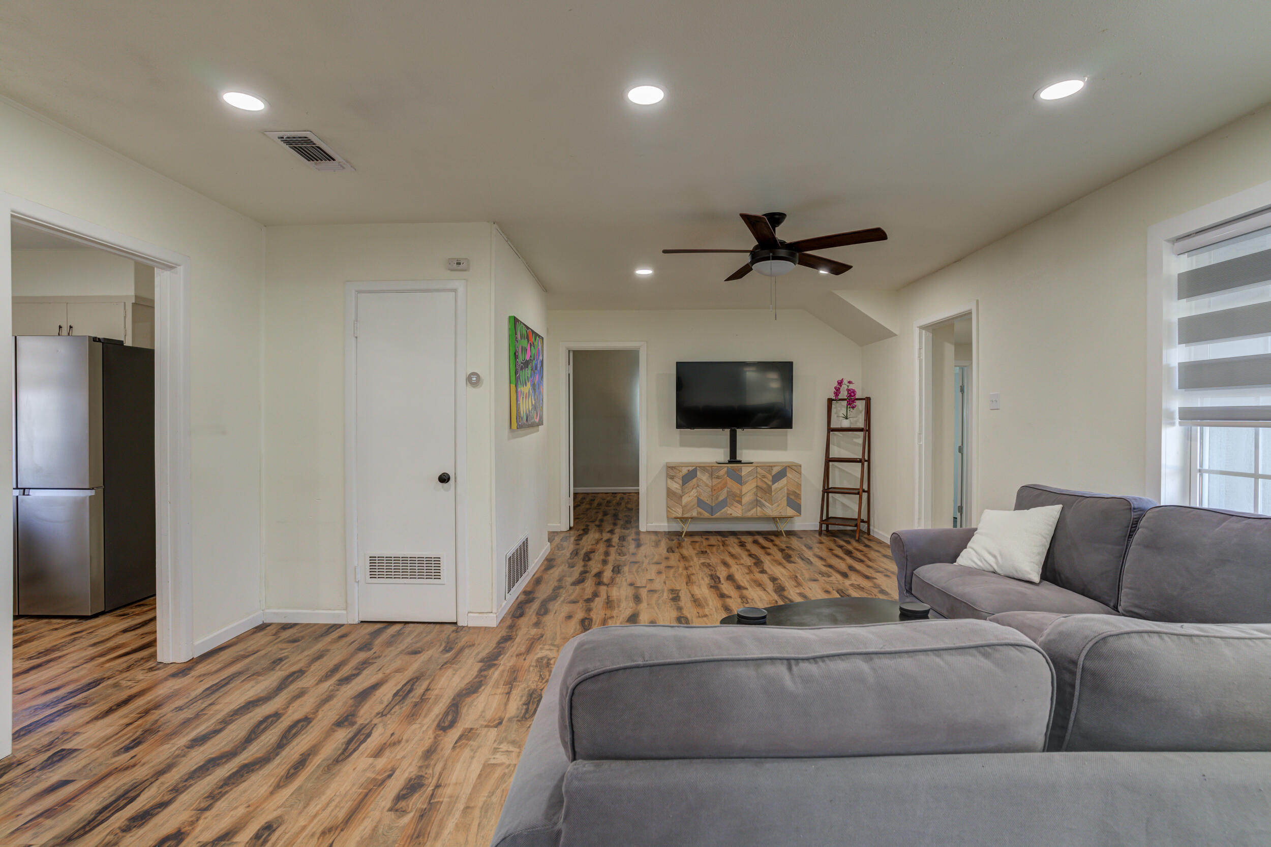 4609 Elgin Avenue Lubbock, TX 79413 - Photo 20 of 46 a living room with furniture and a flat screen tv
