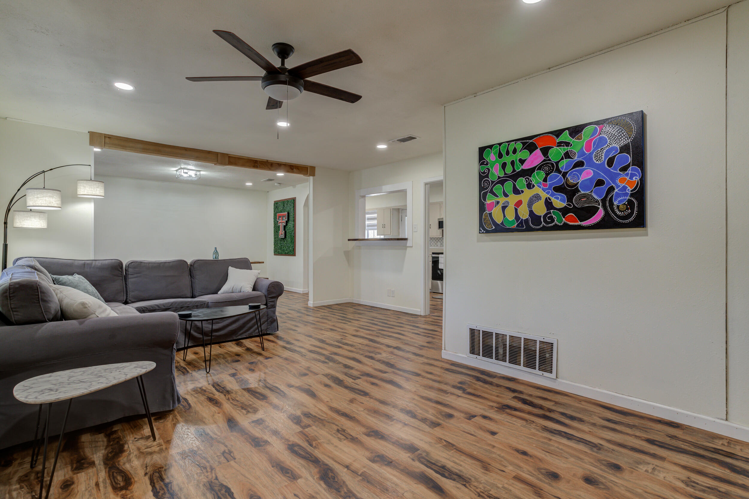 4609 Elgin Avenue Lubbock, TX 79413 - Photo 23 of 46 a living room with furniture and a wooden floor