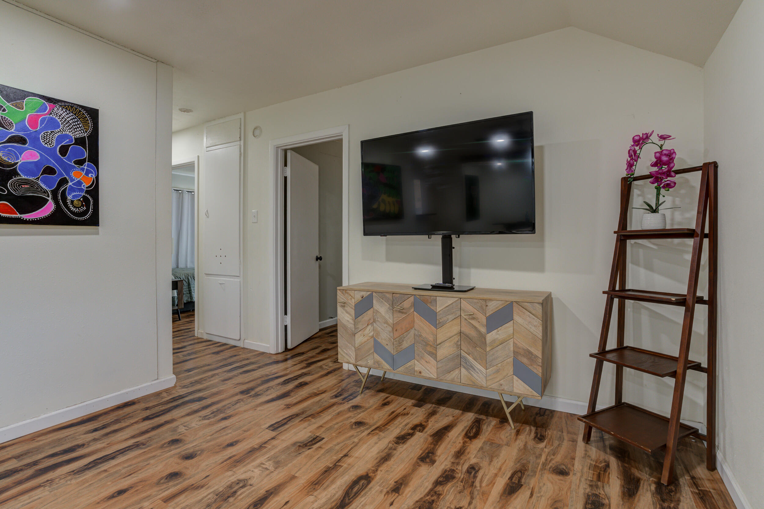 4609 Elgin Avenue Lubbock, TX 79413 - Photo 24 of 46 a living room with furniture and a flat screen tv